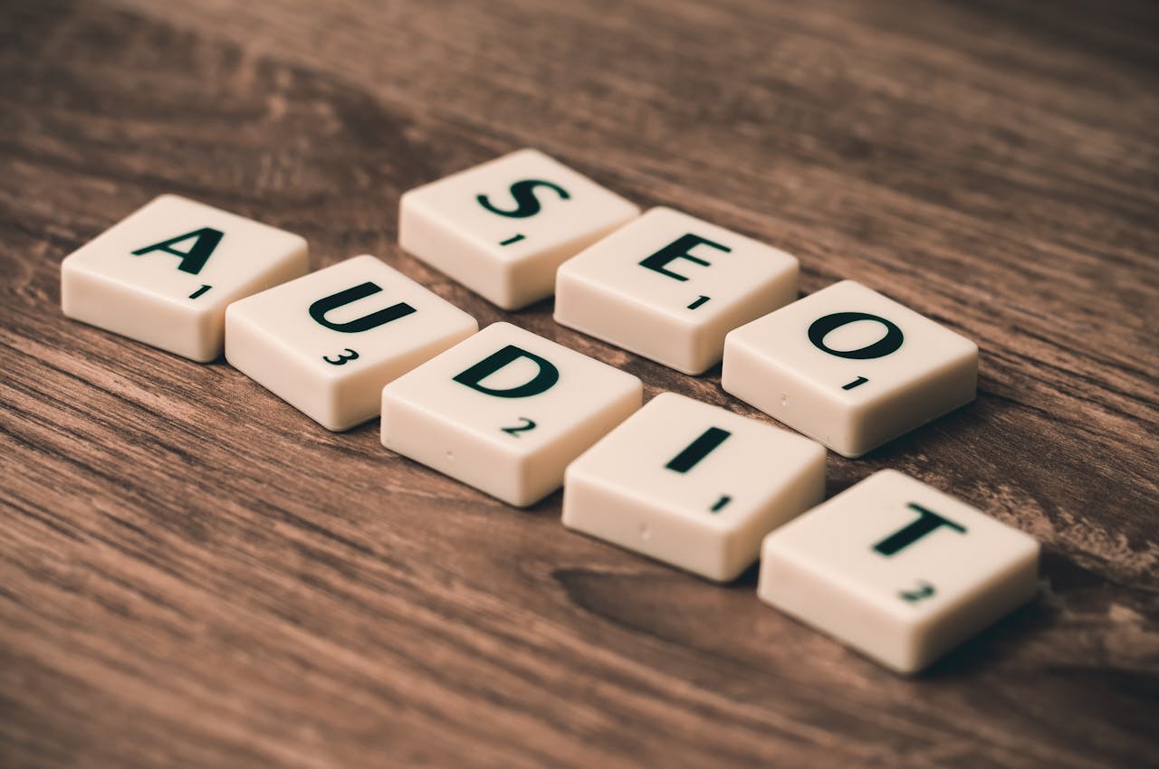 heros-img Scrabble tiles spelling SEO Audit on wooden surface, symbolizing digital marketing strategies.